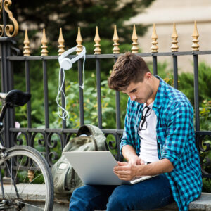 young man studying outdoors